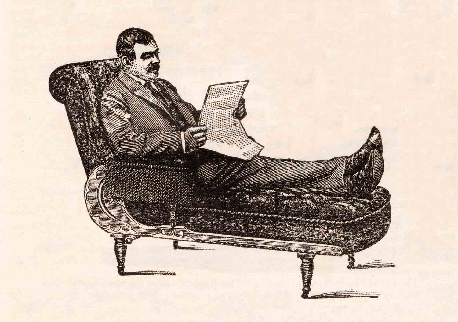 Man Reading Newspaper On Couch